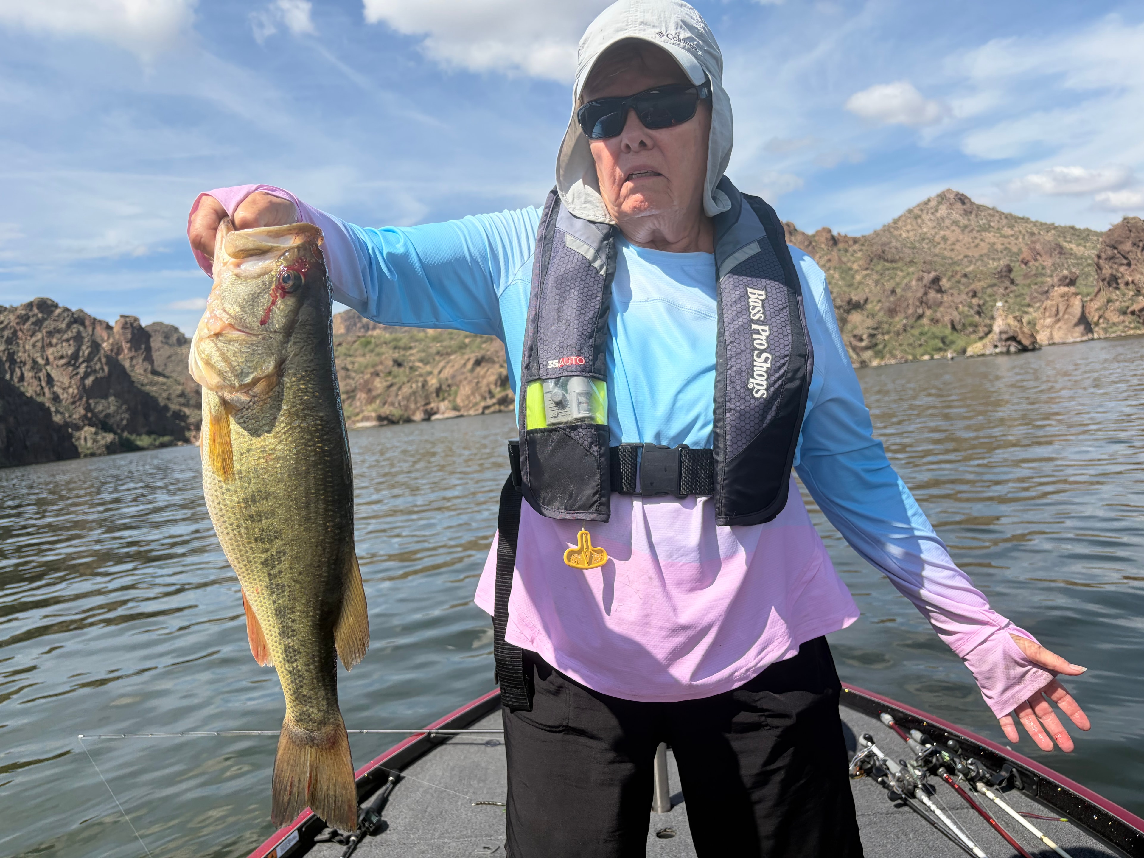 Fisherman holding large bass lake catch