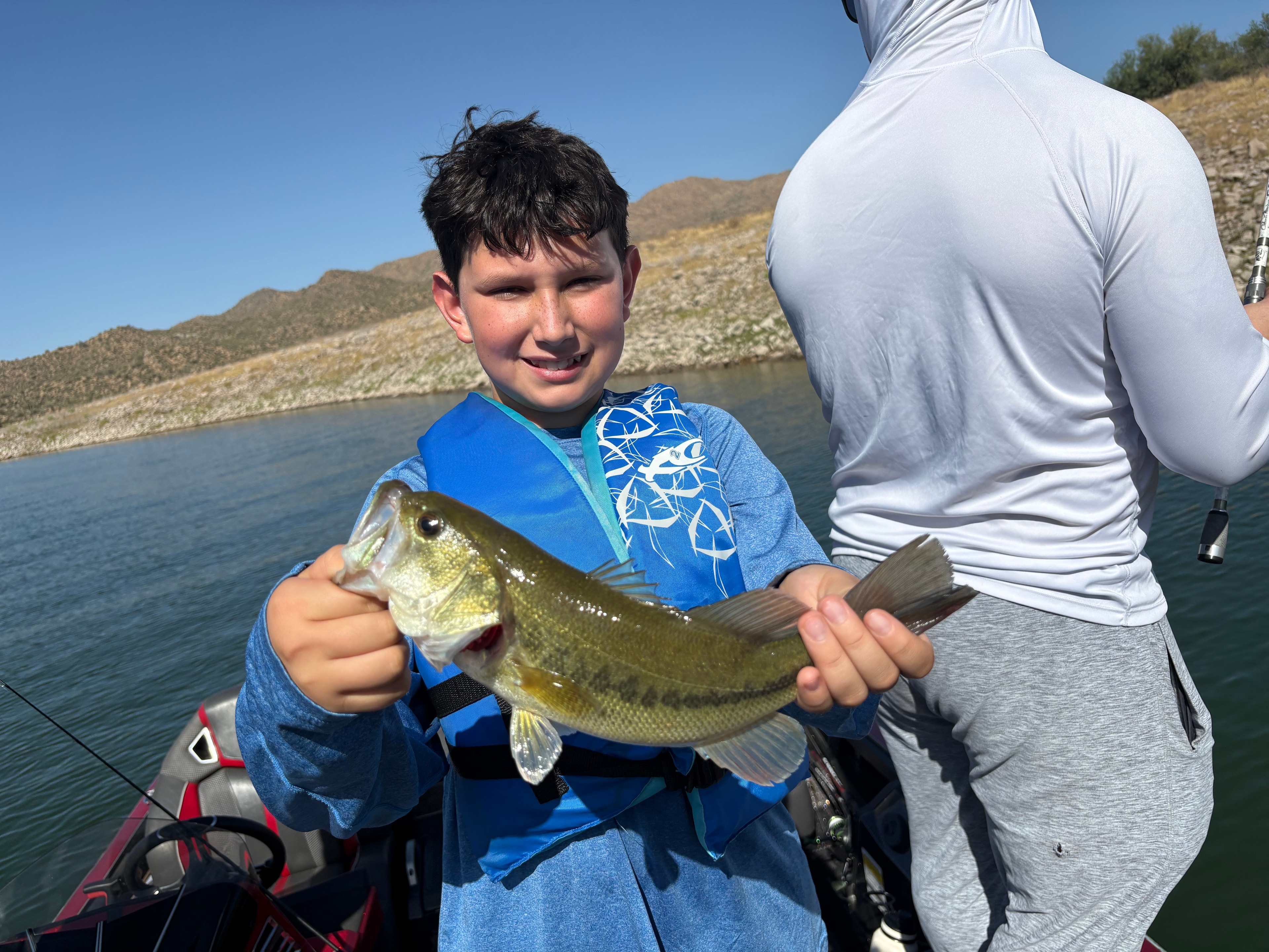 Client holding a fish catch on an Arizona guided fishing trip