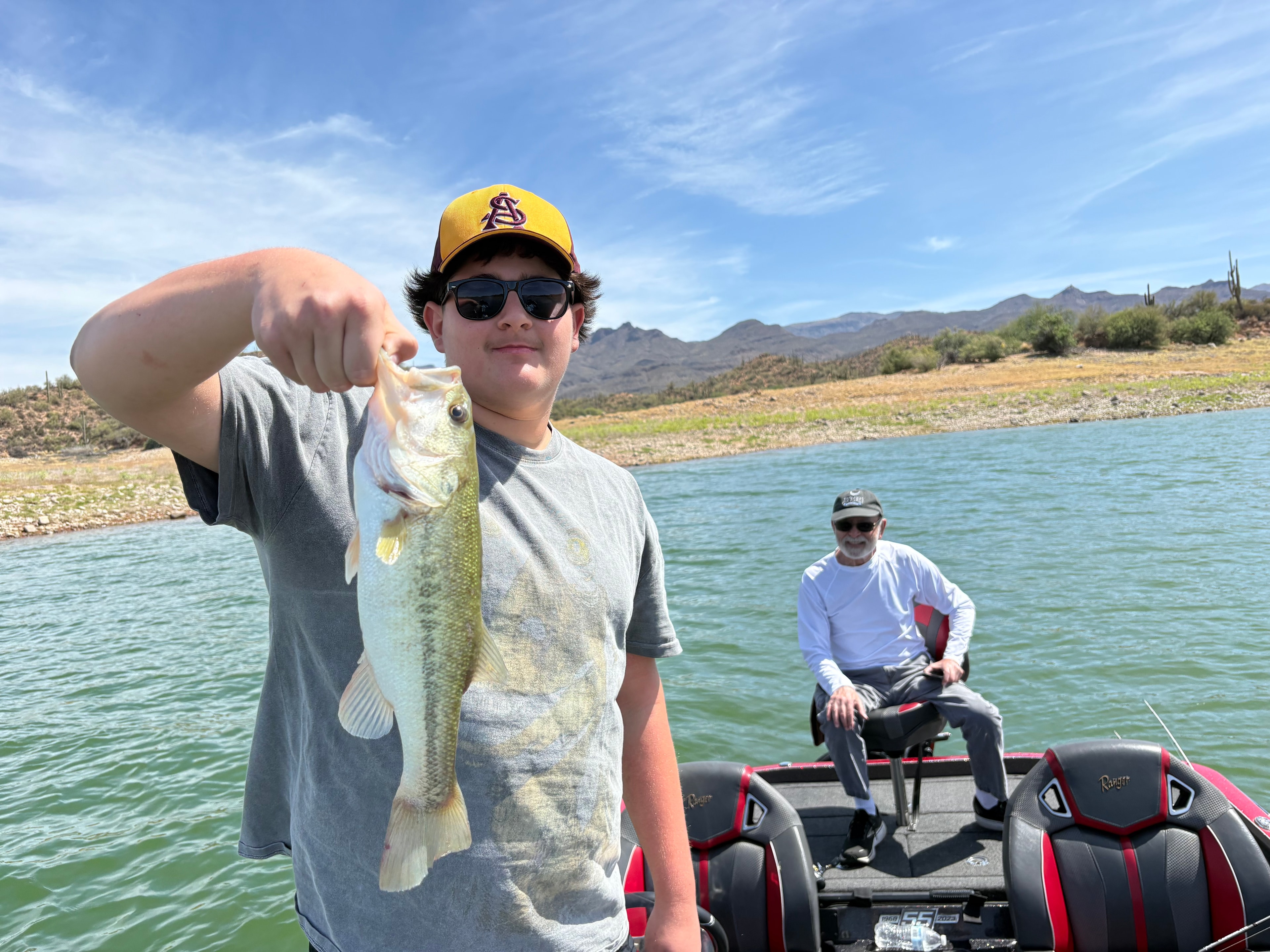 Angler holding a fish catch on an Arizona lake guided trip
