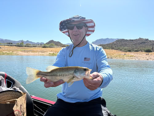 Happy angler with catch on Arizona lake